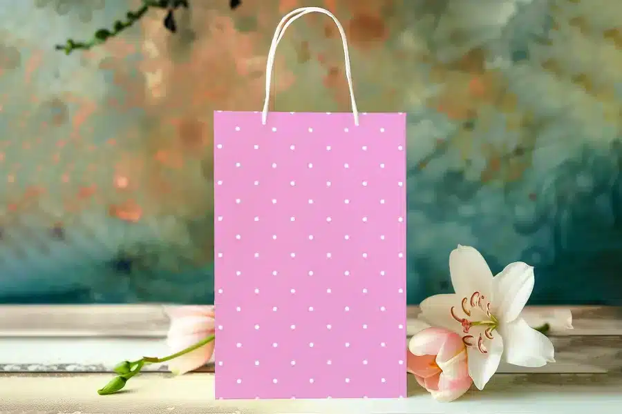 Pink Polka Dot Gift Bag With White Handles.