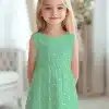 A Young Girl In A Mint Green Polka Dot Dress.