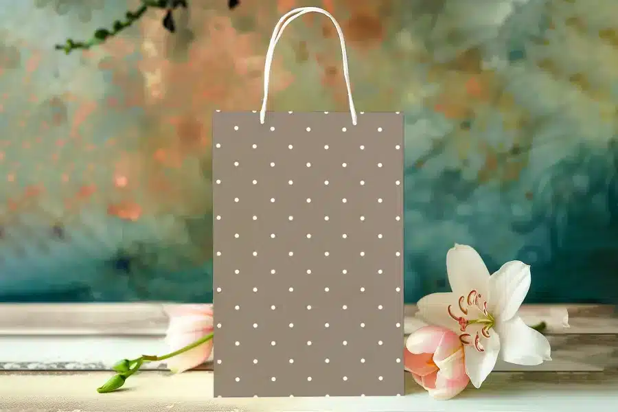 Brown Polka Dot Gift Bag With White Handles.