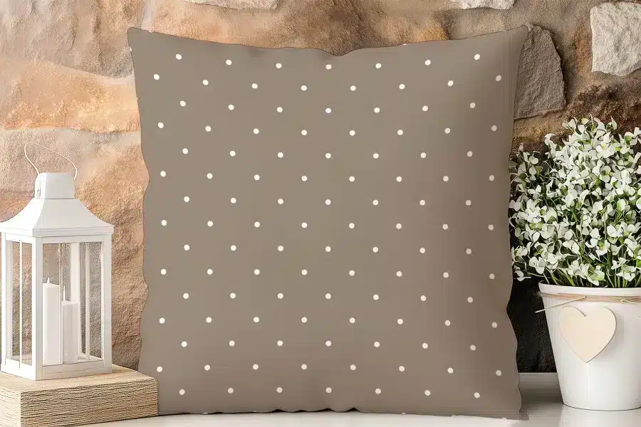 Brown Square Pillow With A White Polka Dot Pattern.