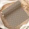 A Roll Of Taupe Wrapping Paper With White Polka Dots.