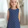 Girl Wearing A Navy Blue Polka Dot Dress.