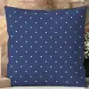 Navy Blue Pillow With A White Polka Dot Pattern.