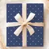 Navy Blue Gift Box With White Polka Dots And A Beige Ribbon.