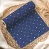 Roll Of Navy Blue Wrapping Paper With White Polka Dots.