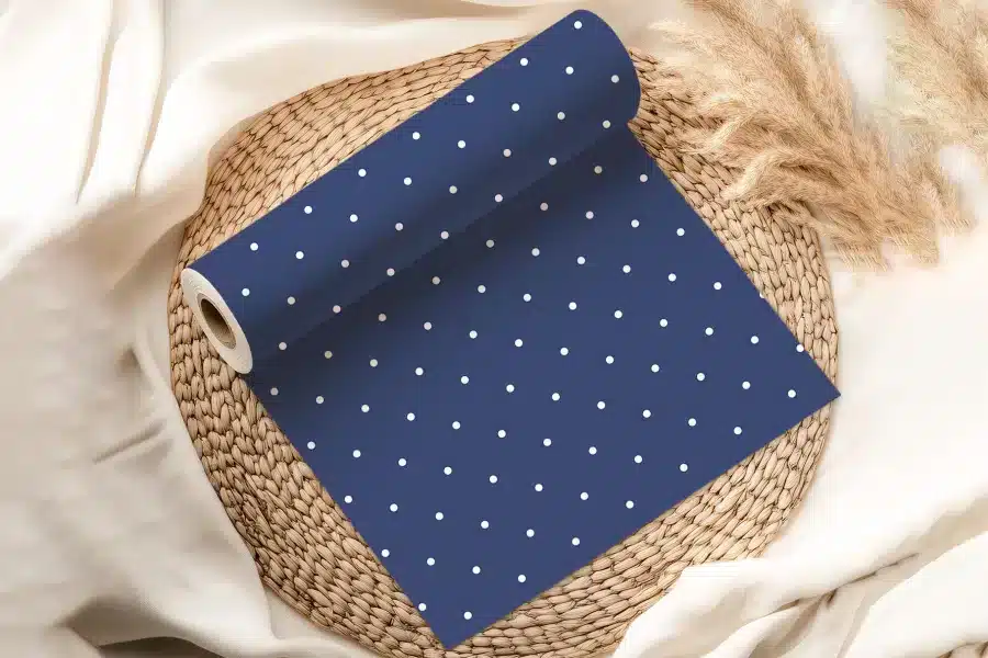 Roll Of Navy Blue Wrapping Paper With White Polka Dots.