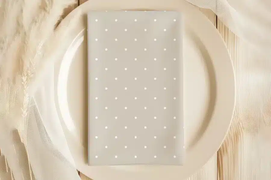 Beige Dinner Plate With A Light Beige Polka Dot Napkin.