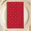 Red Napkin With White Polka Dots On A White Plate.
