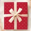 Red Gift Box With White Polka Dots And A Cream-Colored Ribbon.