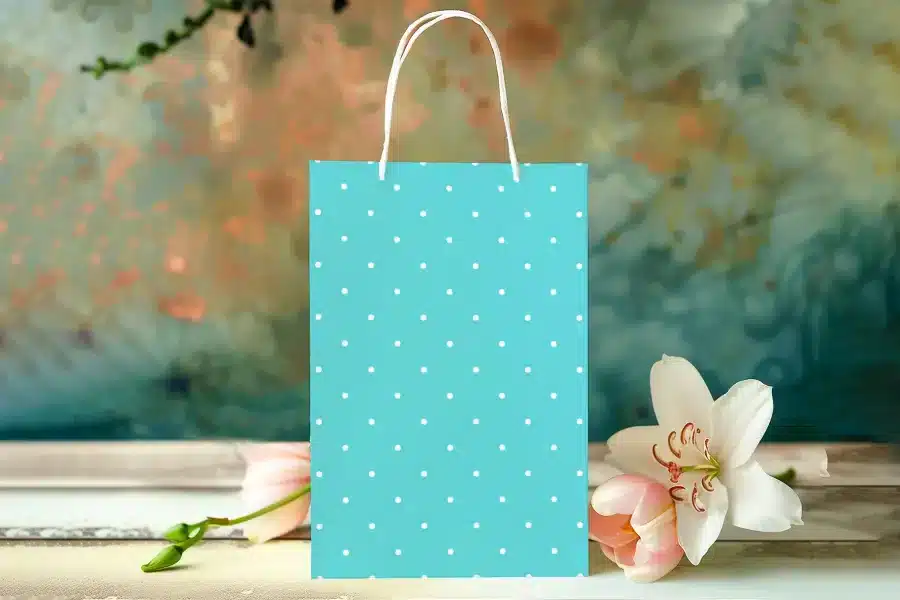 Light Teal Polka Dot Gift Bag With White Handles.