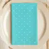 Teal Napkin With White Polka Dots On A Beige Plate.