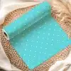 A Roll Of Light Teal Wrapping Paper With White Polka Dots.
