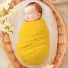 Sleeping Baby Swaddled In A Yellow Polka Dot Wrap.