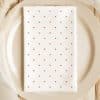 White Dinner Napkin With Small Red Polka Dots, On A Beige Plate.