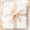 A Gift Box With A Beige Ribbon And Navy Polka Dots.