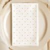 White Napkin With Orange Polka Dots On A Beige Plate.