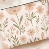 Floral Zippered Pouch With A Light Beige Background.