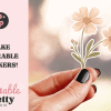 A Hand Holds A Sticker Of Two Light Peach Flowers And Stems.