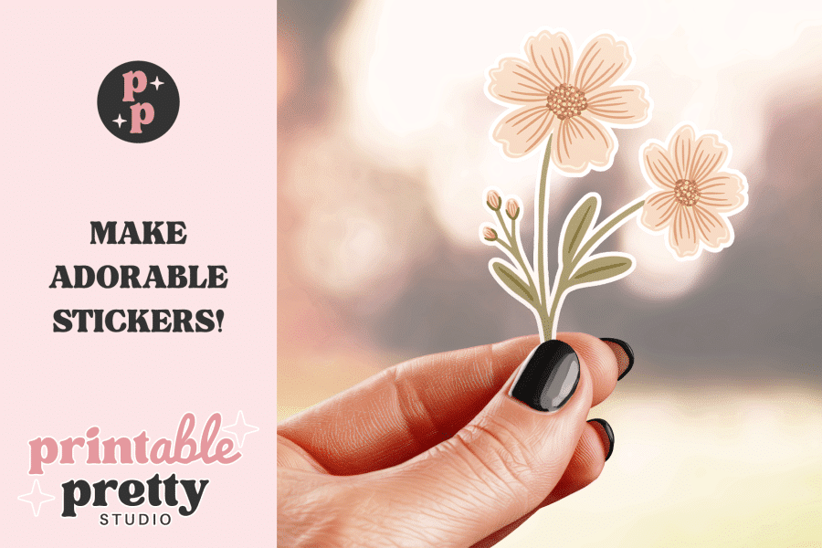 A Hand Holds A Sticker Of Two Light Peach Flowers And Stems.