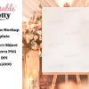 Chic Garden Wedding Sign Mockup Blank Sign On Easel In Front Of Blurred Floral Arrangement.