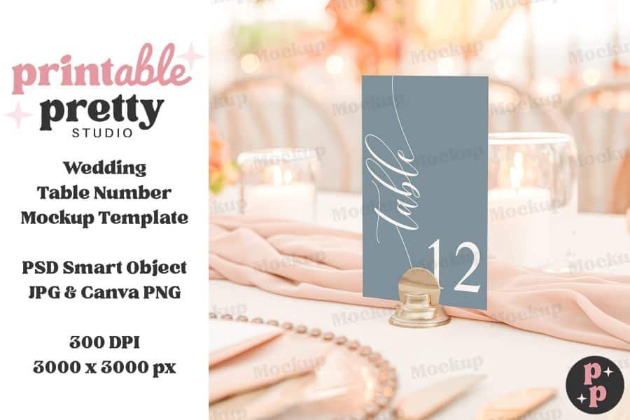 A Blue Wedding Table Number Card, Displaying The Number 12, Sits On A Gold Stand On A Table.