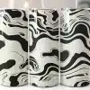 Three Tall Tumblers With Black And Off-White Swirling Designs.