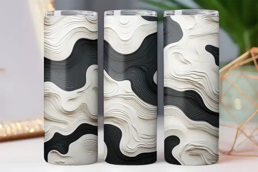 Three tumblers with a black and off-white abstract wave design.
