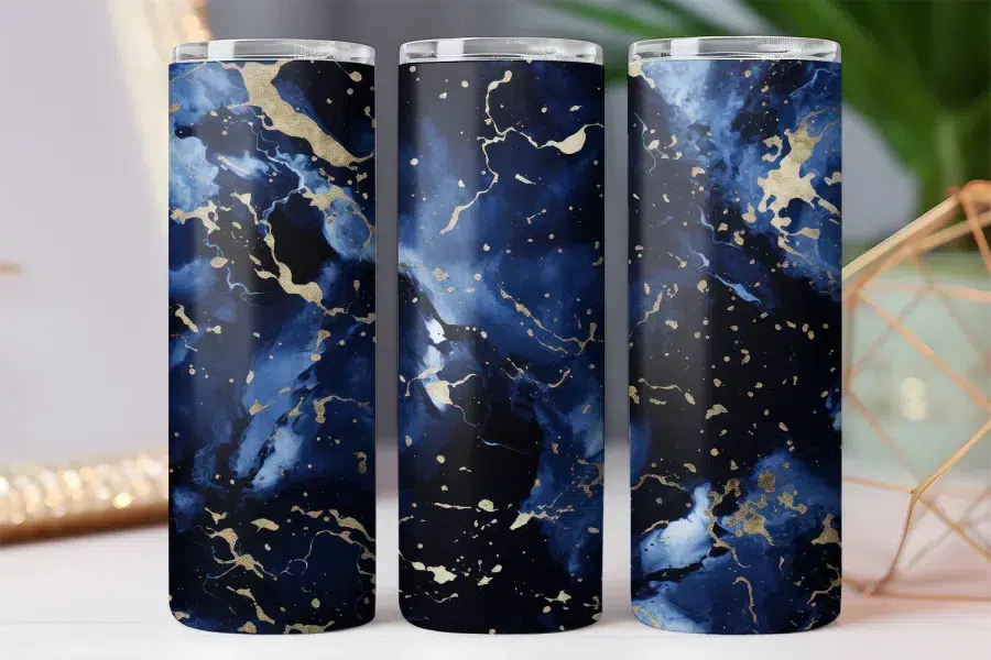 Three navy blue and gold marble tumblers.