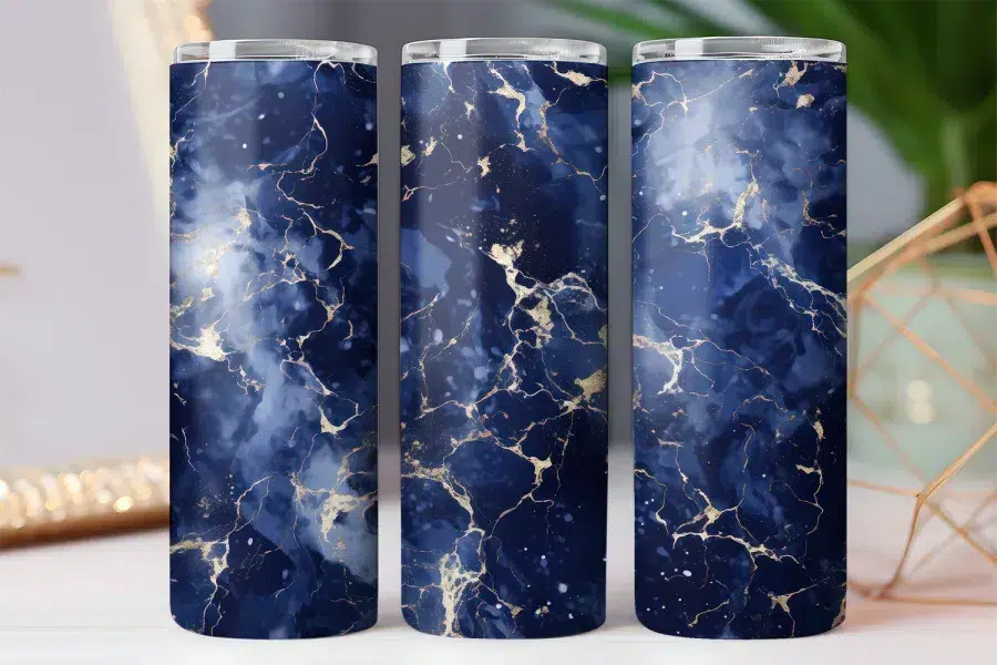 Three navy blue tumblers with gold veining.