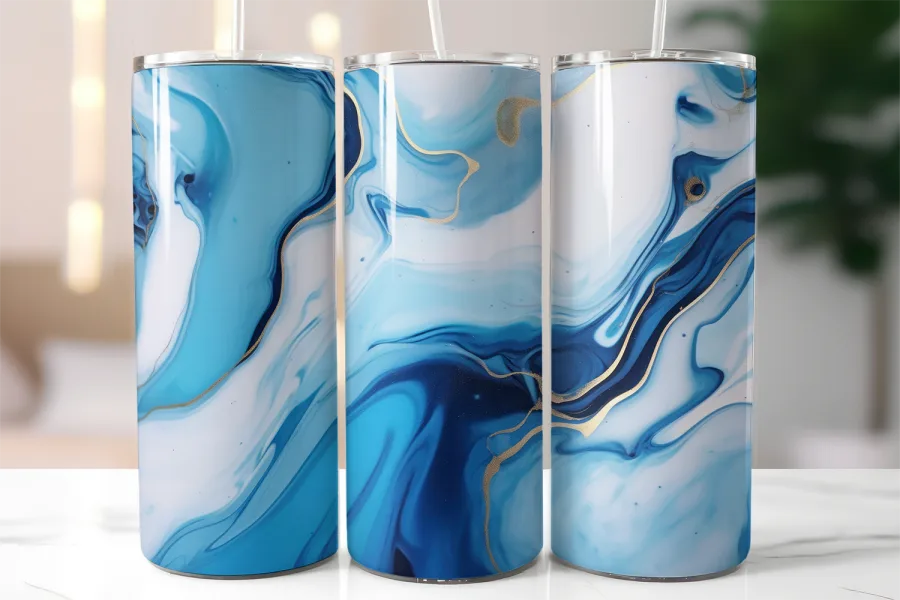 Three Blue And Gold Marble Patterned Tumblers With Straws.