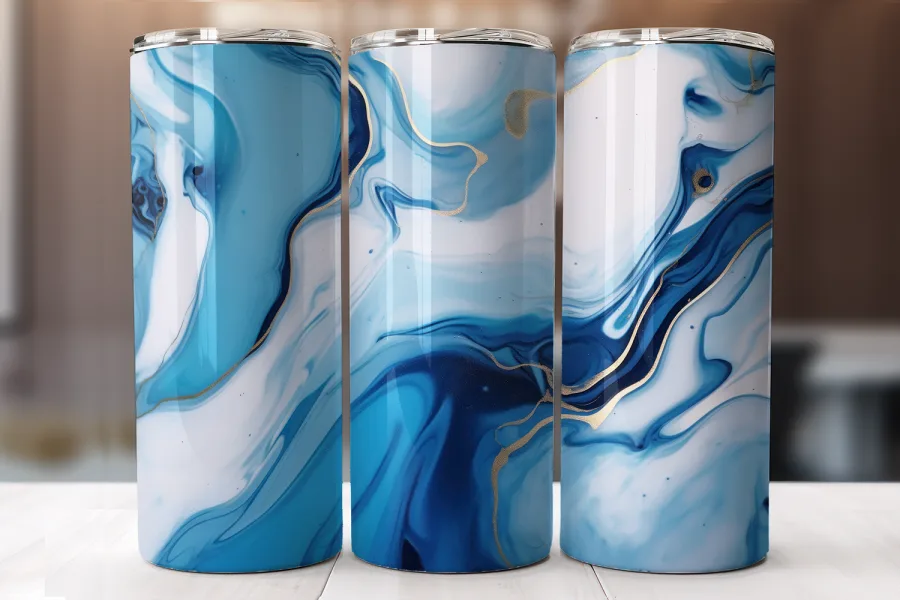 Three Blue And White Marble-Patterned Tumblers With Gold Accents.