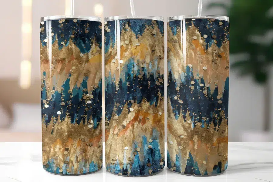 Three Tall Tumblers With Lids And Straws, Featuring An Abstract Design Of Blue, Gold, And Tan Brushstrokes And Glitter.