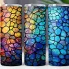 Three Tumblers With A Stained-Glass Style Design.  The Designs Feature Multicolored, Irregular Shapes Separated By Black Lines.  One Tumbler Is Predominantly Warm Colors, One Cool Colors, And The Other A Mix Of Both.