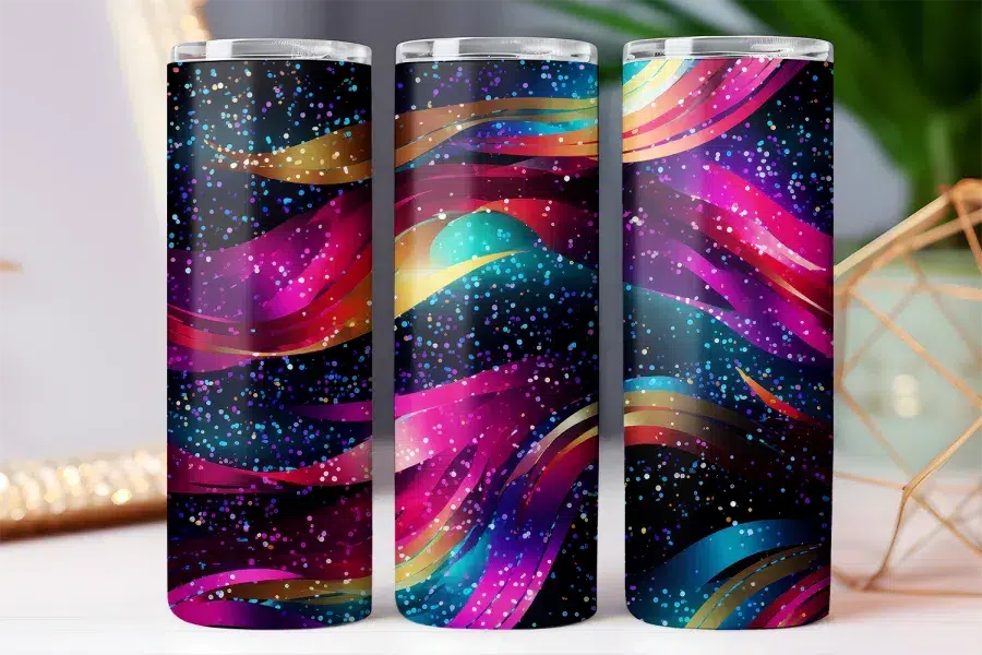 Three tumblers with a dark background and colorful, glittering, wavy designs.