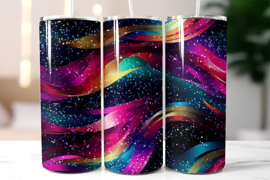 Three Stainless Steel Tumblers With A Dark Background And Colorful Glitter Wave Design.