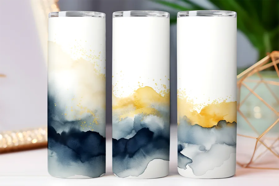 Three tall tumblers with an abstract design of yellow and blue watercolor washes and gold accents.