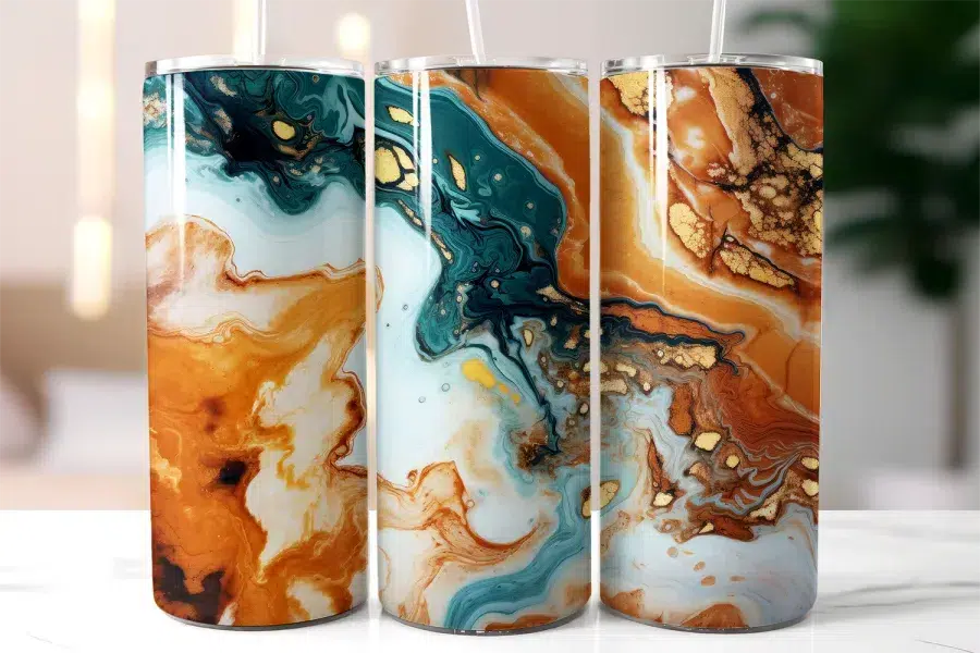 Three Tall Tumblers With Abstract Marble Designs In Teal, Orange, And Gold.