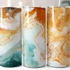 Three Tall Tumblers With Abstract Marble Designs In Teal, Blue, And Gold.