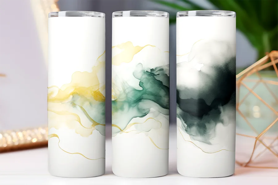 Three white tumblers with abstract gold and green watercolor designs.