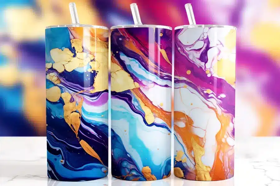 Multicolor marble Tumbler Wrap design with swirling vibrant ink in purple, blue, orange, and pink tones accented by faux gold veining on 20oz skinny tumblers.