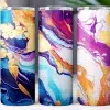 Three Tumblers With Abstract Marble Designs In Purple, Blue, And Orange With Gold Accents.