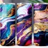 Three Tumblers With Abstract Purple, Blue, And Gold Marble Designs.