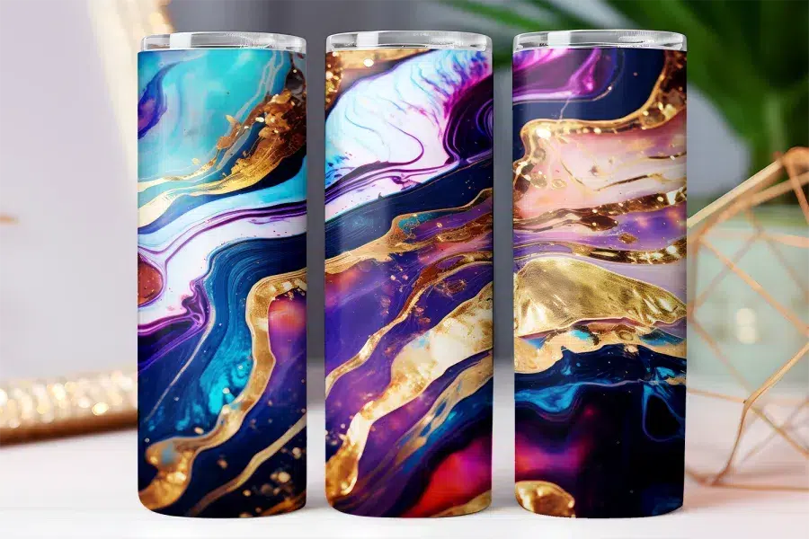 Three tumblers with abstract purple, blue, and gold marble designs.