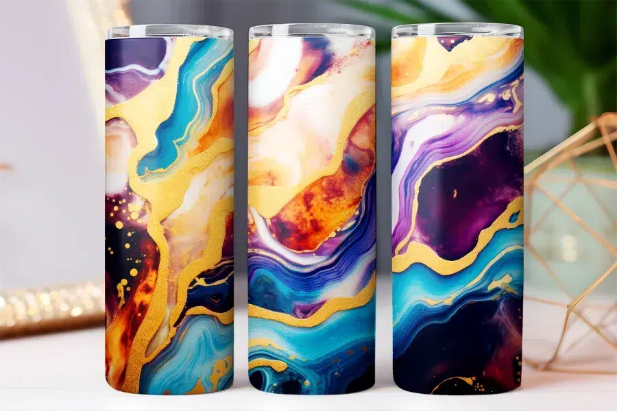Three tall tumblers with an abstract design featuring swirling blues, purples, oranges, and gold accents.