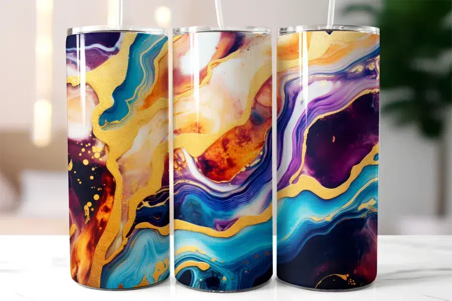 Three Tall Tumblers With Abstract Marble Designs In Teal, Purple, Gold, And Orange.