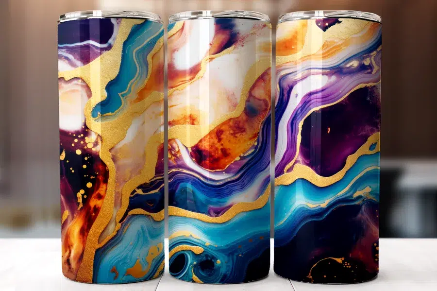 Three Stainless Steel Tumblers With Abstract Marble Designs In Shades Of Blue, Purple, Gold, And Orange.