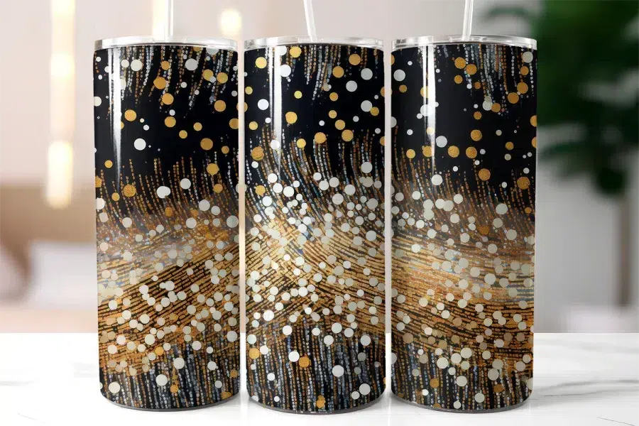 Three Black Tumblers With Gold And White Confetti Designs.