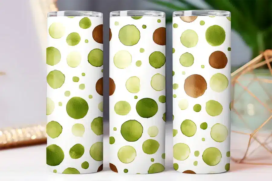 Three tumblers with a watercolor polka dot design in shades of green and brown.