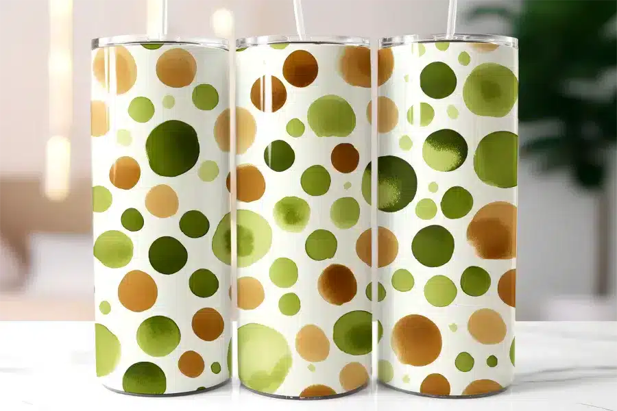 Three Tall Tumblers With Straws, Featuring A Pattern Of Watercolor-Style Green And Brown Circles On A White Background.