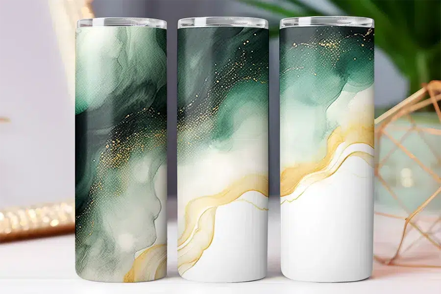 Three tumblers with an abstract design of green and gold watercolor-style swirls on a white background.